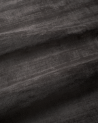 Amara viscose hand-loomed area rug in Black, draped to show the sheen