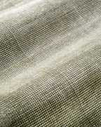 Sage green textured velvet rug with subtle worn vintage distressing throughout