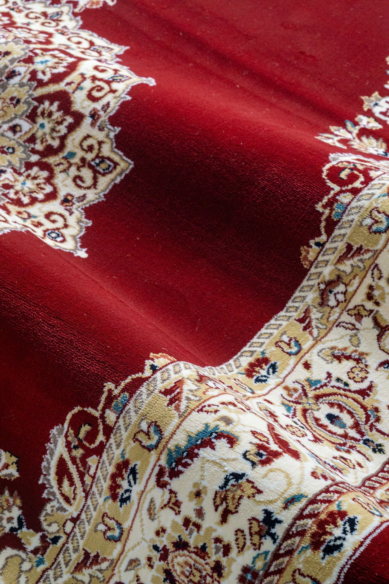 Burgundy traditional rug with ornate gold and cream floral medallion pattern