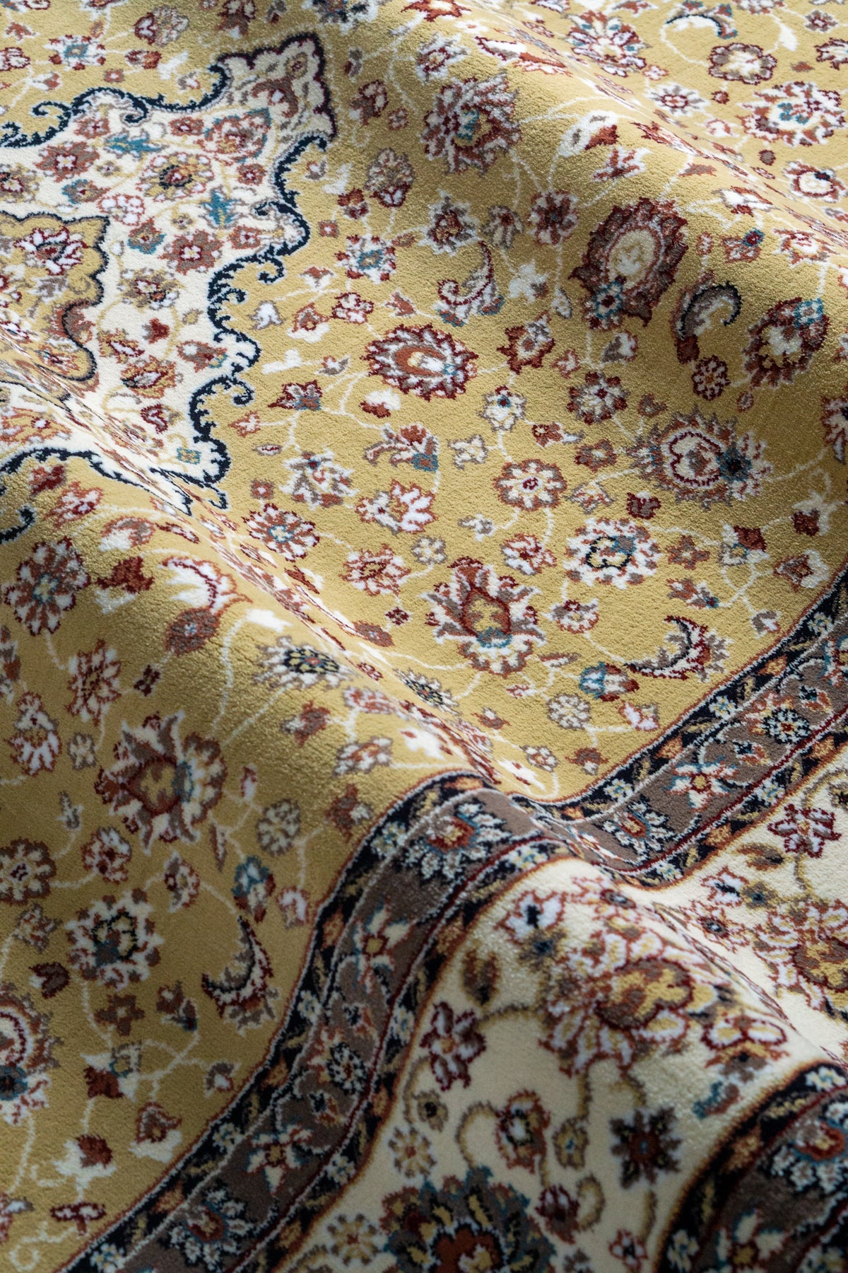 Traditional Persian rug with gold center, cream border and ornate floral medallion pattern