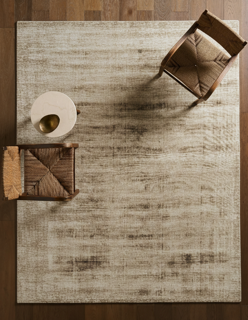 Distressed tan and brown textured area rug with worn vintage appearance