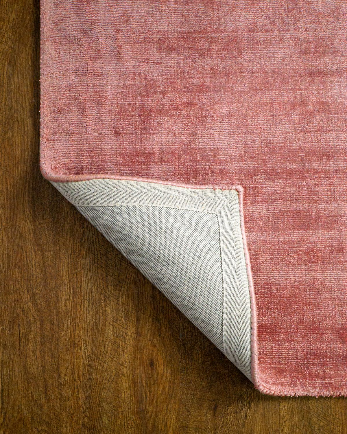 Amara viscose hand-loomed area rug in Coral Pink, backing view