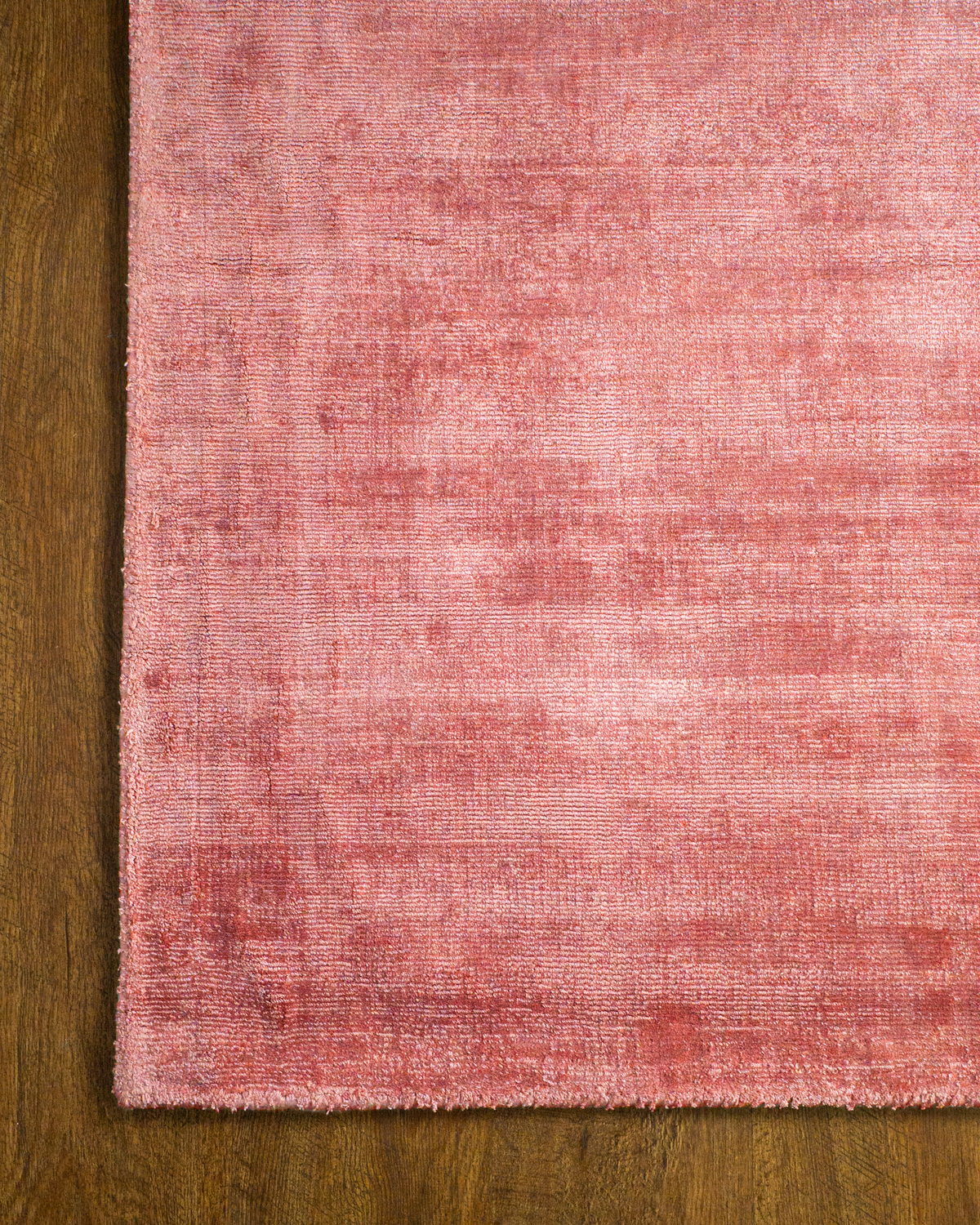 Amara viscose hand-loomed area rug in Coral Pink, corner detail