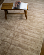Amara viscose hand-loomed area rug in Dark Brown, styled in a living room