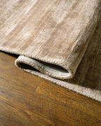 Amara viscose hand-loomed area rug in Dark Brown, curled edge detail