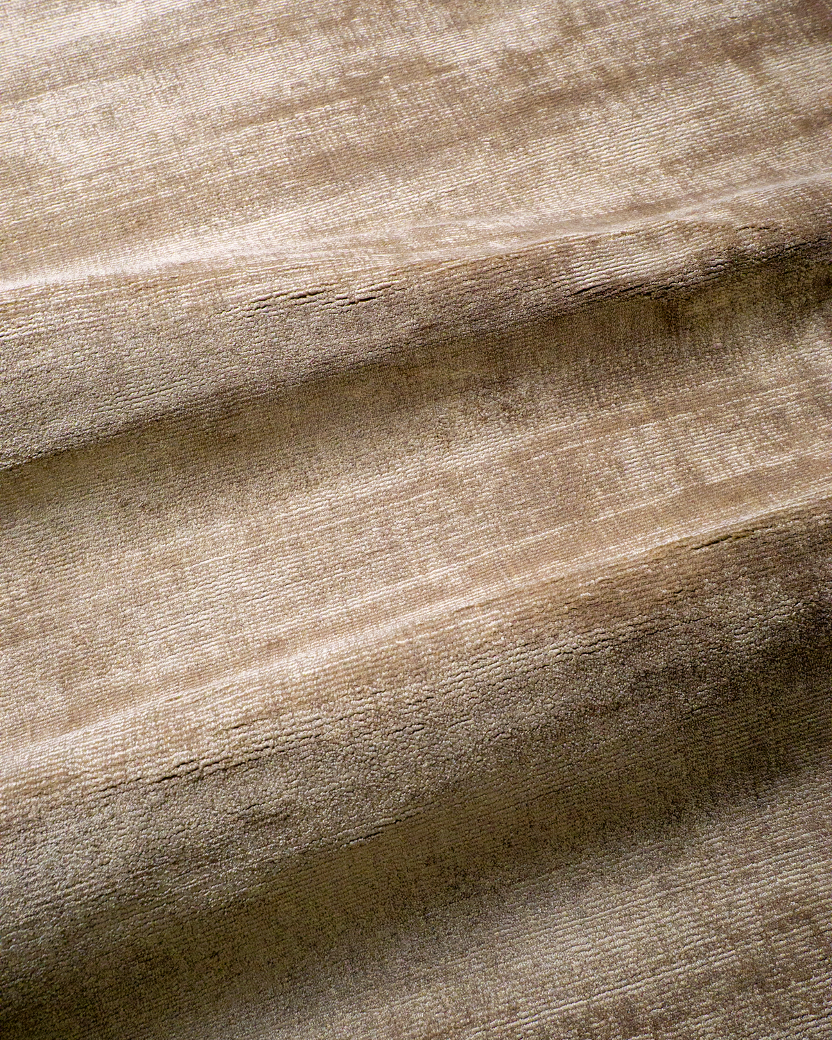 Amara viscose hand-loomed area rug in Dark Brown, draped to show the sheen