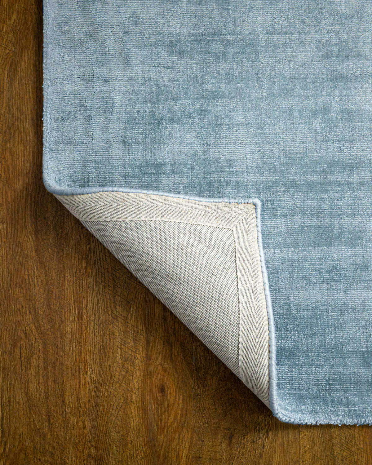 Amara viscose hand-loomed area rug in Dark Cyan, backing view