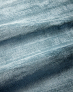 Amara viscose hand-loomed area rug in Dark Cyan, draped to show the sheen