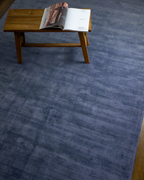 Amara viscose hand-loomed area rug in Deep Navy, styled in a living room