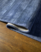 Amara viscose hand-loomed area rug in Deep Navy, curled edge detail