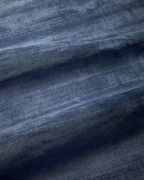 Amara viscose hand-loomed area rug in Deep Navy, draped to show the sheen