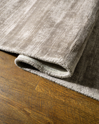 Amara viscose hand-loomed area rug in Dusk Grey, curled edge detail