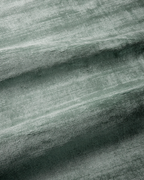 Amara viscose hand-loomed area rug in Evergreen, draped to show the sheen