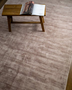 Amara viscose hand-loomed area rug in Light Mauve, styled in a living room