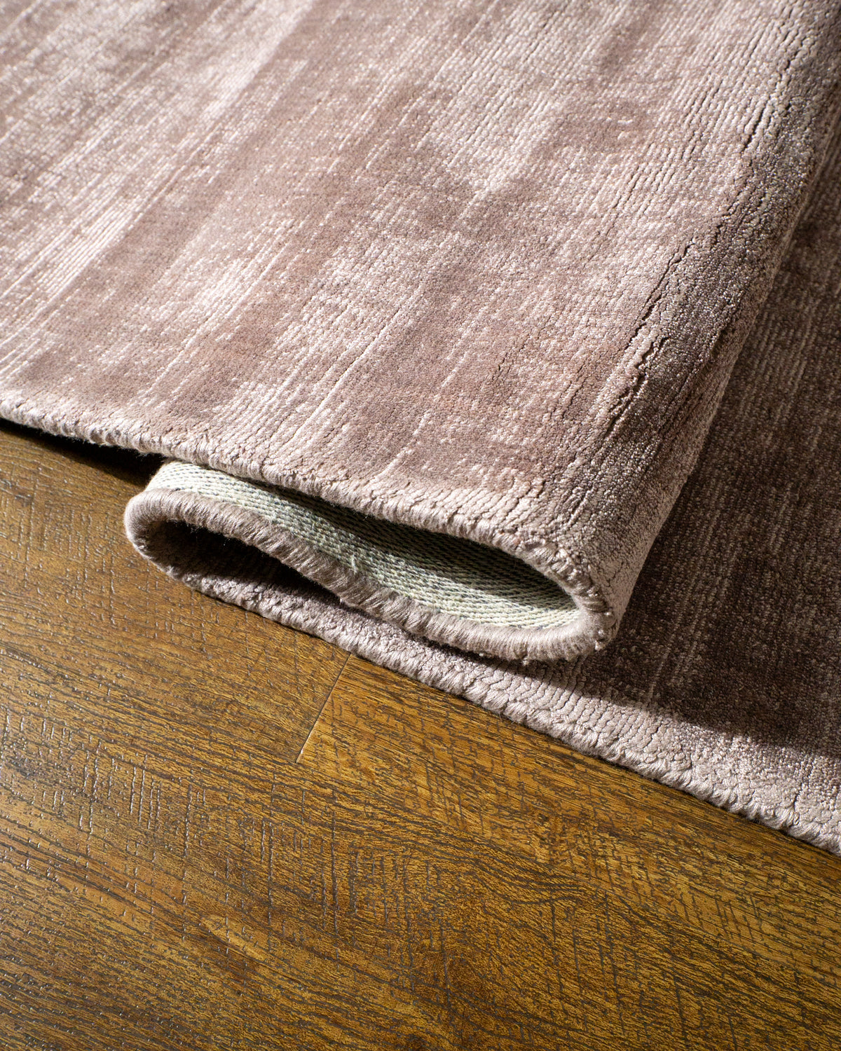 Amara viscose hand-loomed area rug in Light Mauve, curled edge detail