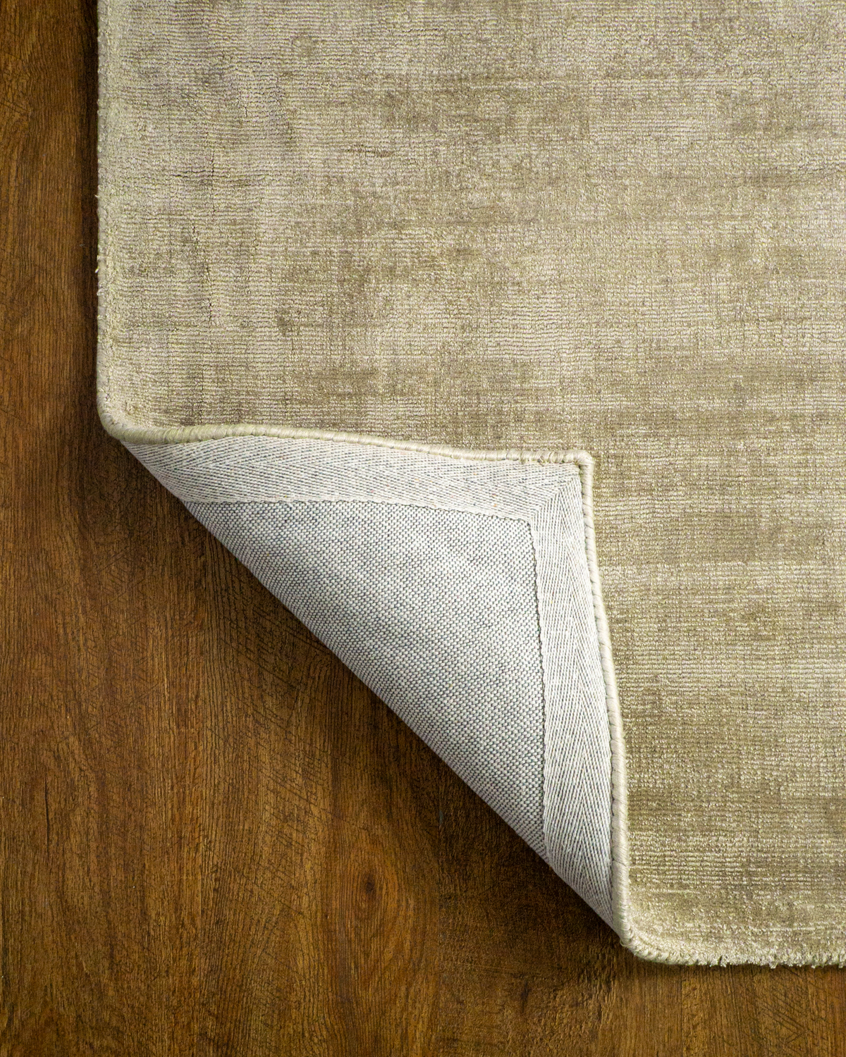 Amara viscose hand-loomed area rug in Olive Brown, backing view