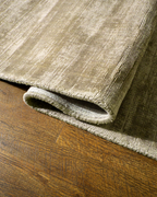 Amara viscose hand-loomed area rug in Olive Brown, curled edge detail