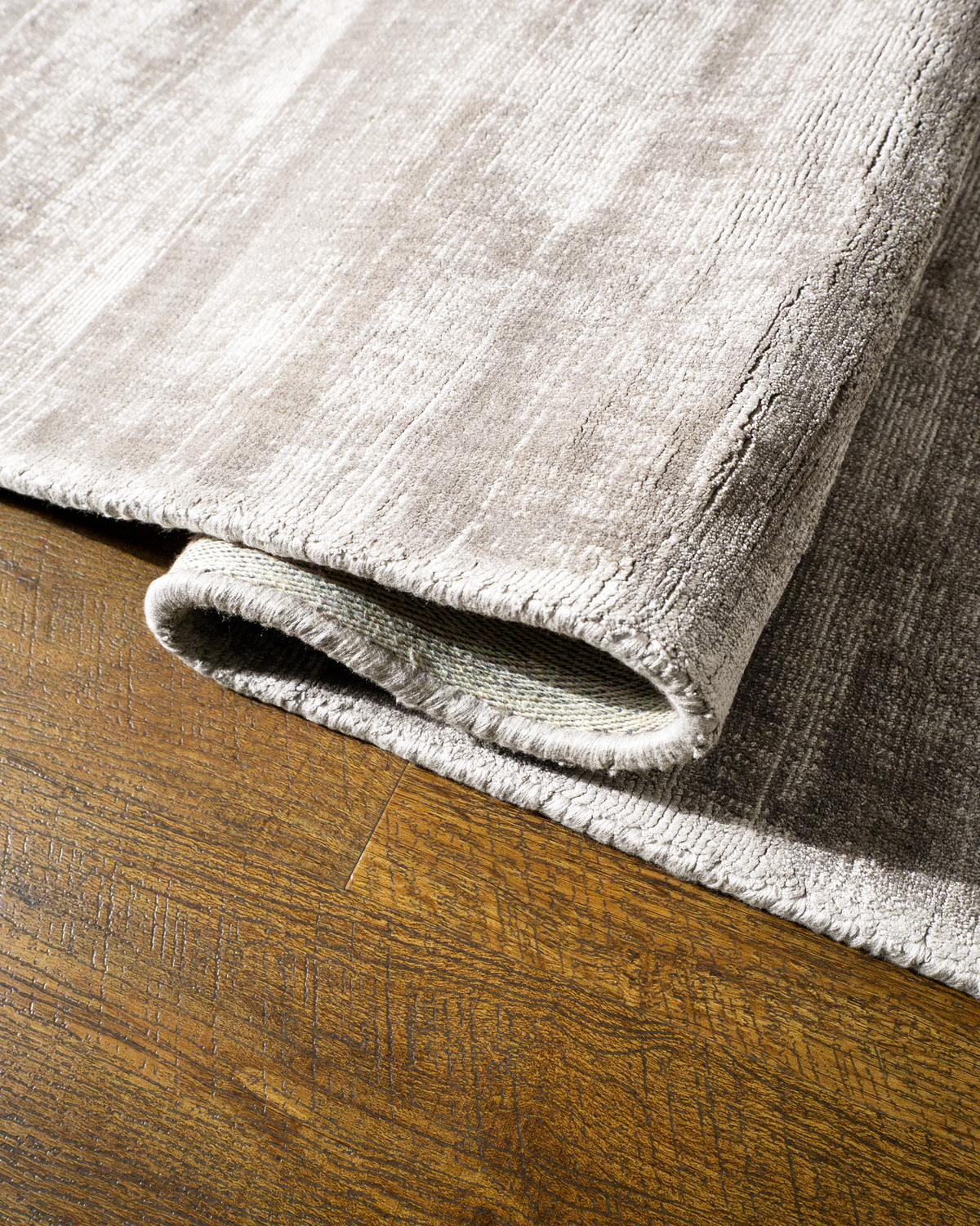 Amara viscose hand-loomed area rug in Pearl, curled edge detail