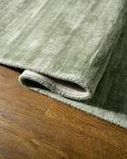 Amara viscose hand-loomed area rug in Sage, curled edge detail