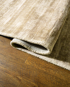 Amara viscose hand-loomed area rug in Shell Beige, curled edge detail