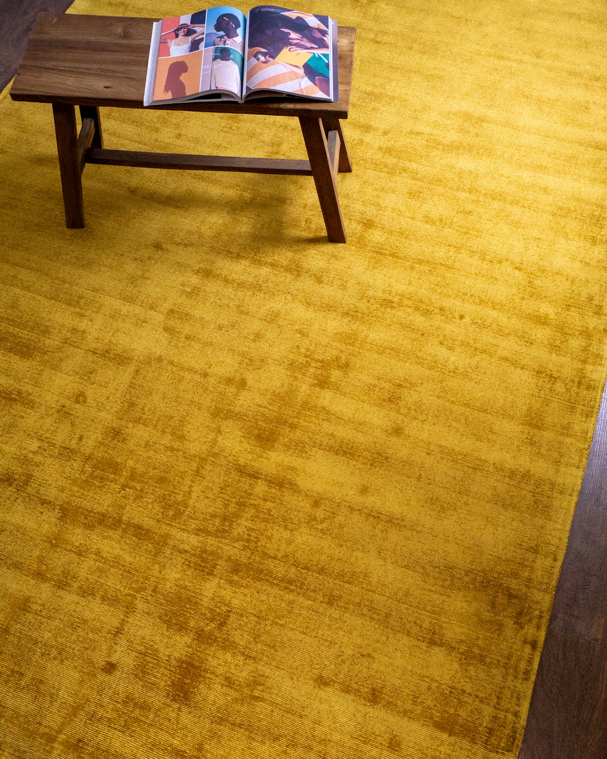 Amara viscose hand-loomed area rug in Yellow, styled in a living room