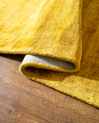Amara viscose hand-loomed area rug in Yellow, curled edge detail