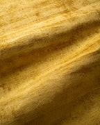 Amara viscose hand-loomed area rug in Yellow, draped to show the sheen
