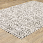 Modern geometric patterned rug in cream and brown tones on wood flooring