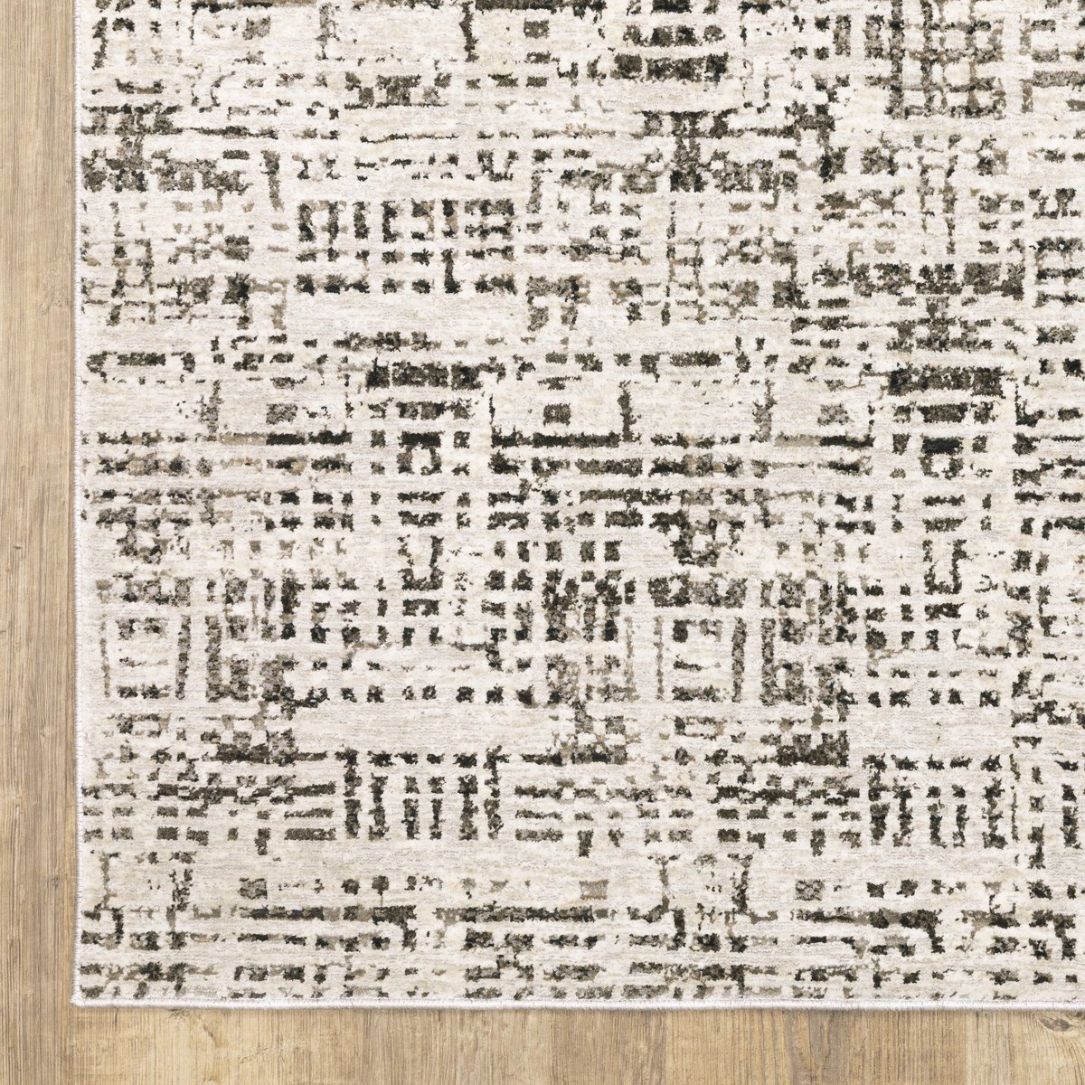 Modern geometric patterned rug in cream and brown tones on wood flooring