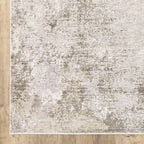 Distressed beige and grey textured rug with mottled vintage appearance