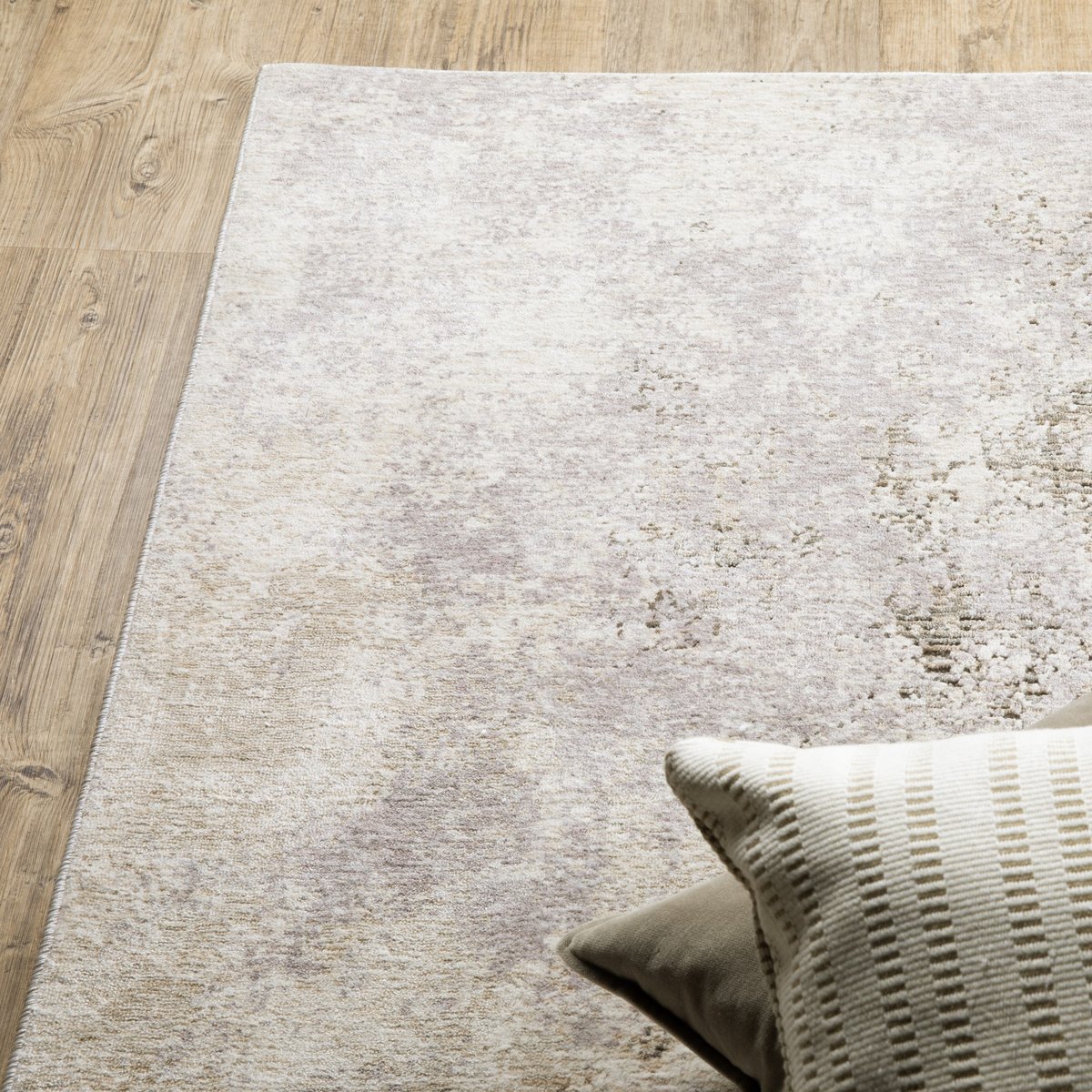 Distressed beige and grey textured rug with mottled vintage appearance