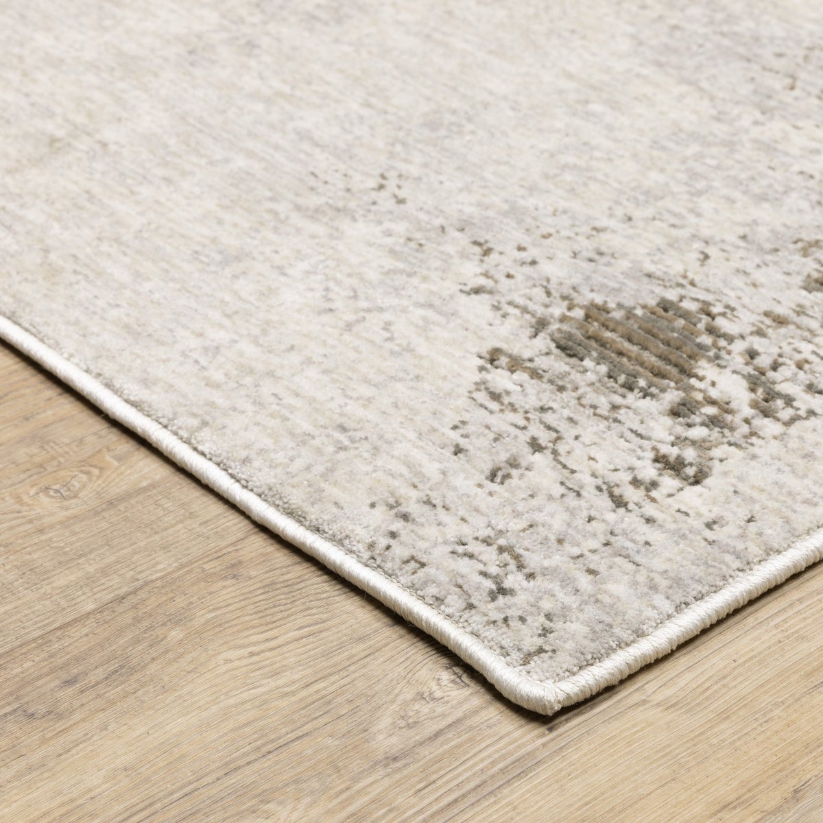 Distressed beige and grey textured rug with mottled vintage appearance