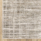 Beige textured area rug with abstract grid pattern on light wood flooring