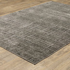 Gray textured area rug with white linear crosshatch pattern throughout