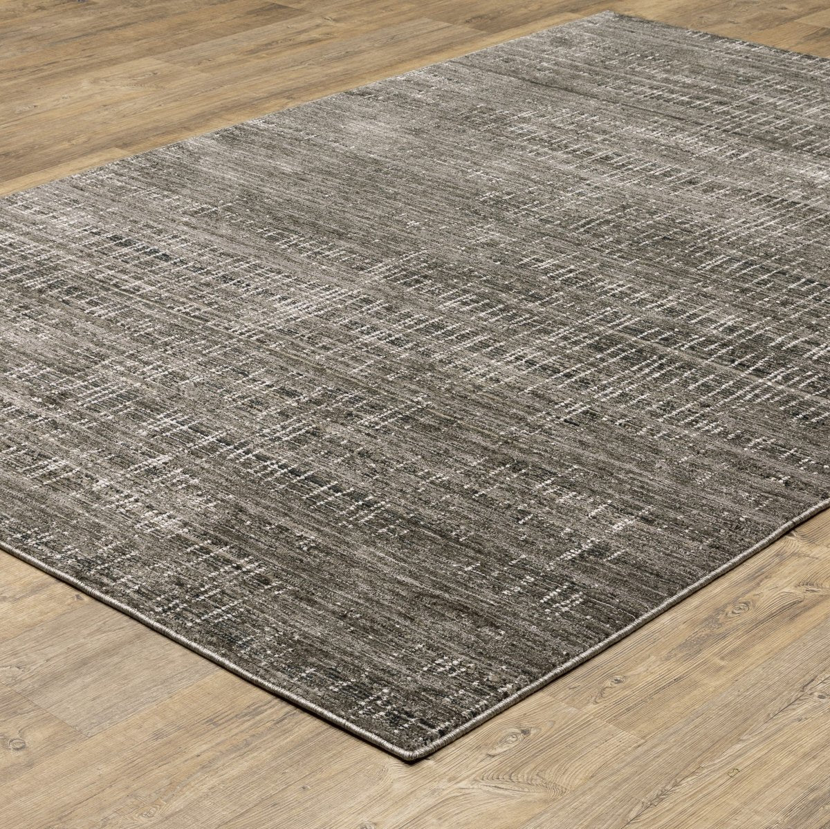 Gray textured area rug with white linear crosshatch pattern throughout