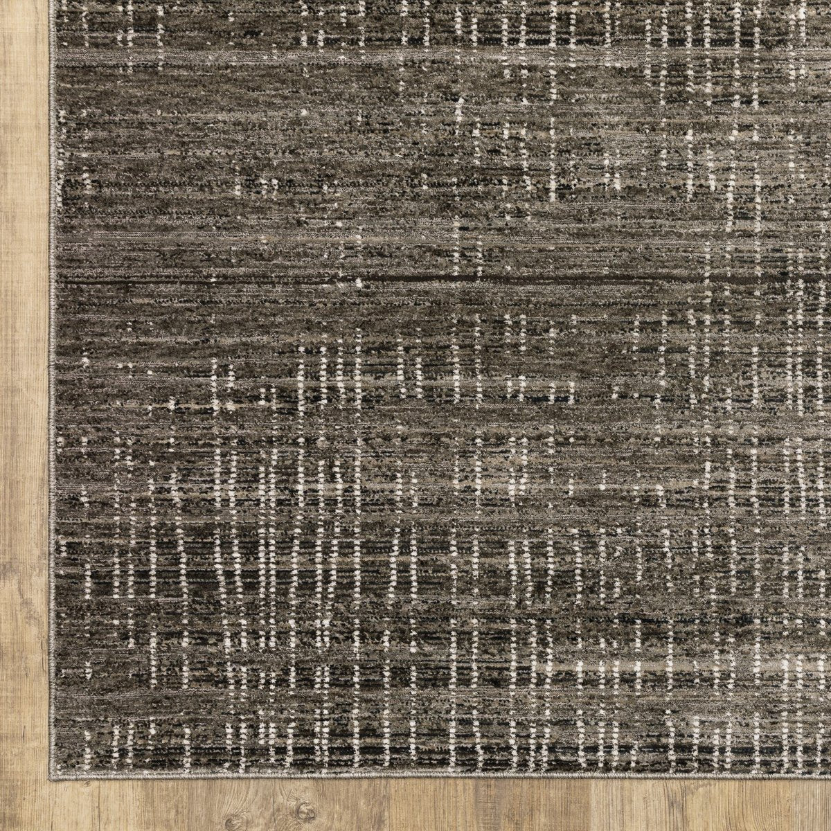 Gray textured area rug with white linear crosshatch pattern throughout
