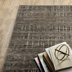 Gray textured area rug with white linear crosshatch pattern throughout