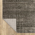 Gray textured area rug with white linear crosshatch pattern throughout