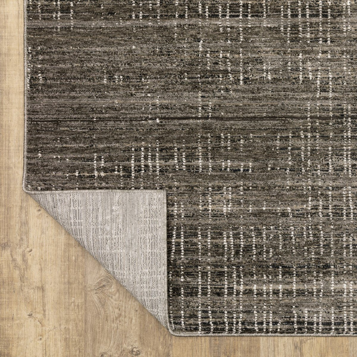 Gray textured area rug with white linear crosshatch pattern throughout