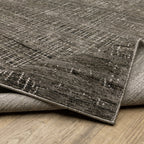 Gray textured area rug with white linear crosshatch pattern throughout