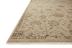 Beige and tan distressed floral pattern rug on dark wood flooring