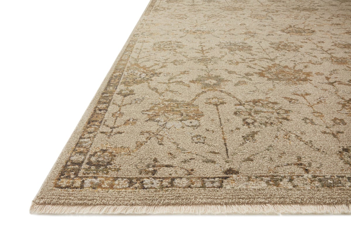 Beige and tan distressed floral pattern rug on dark wood flooring