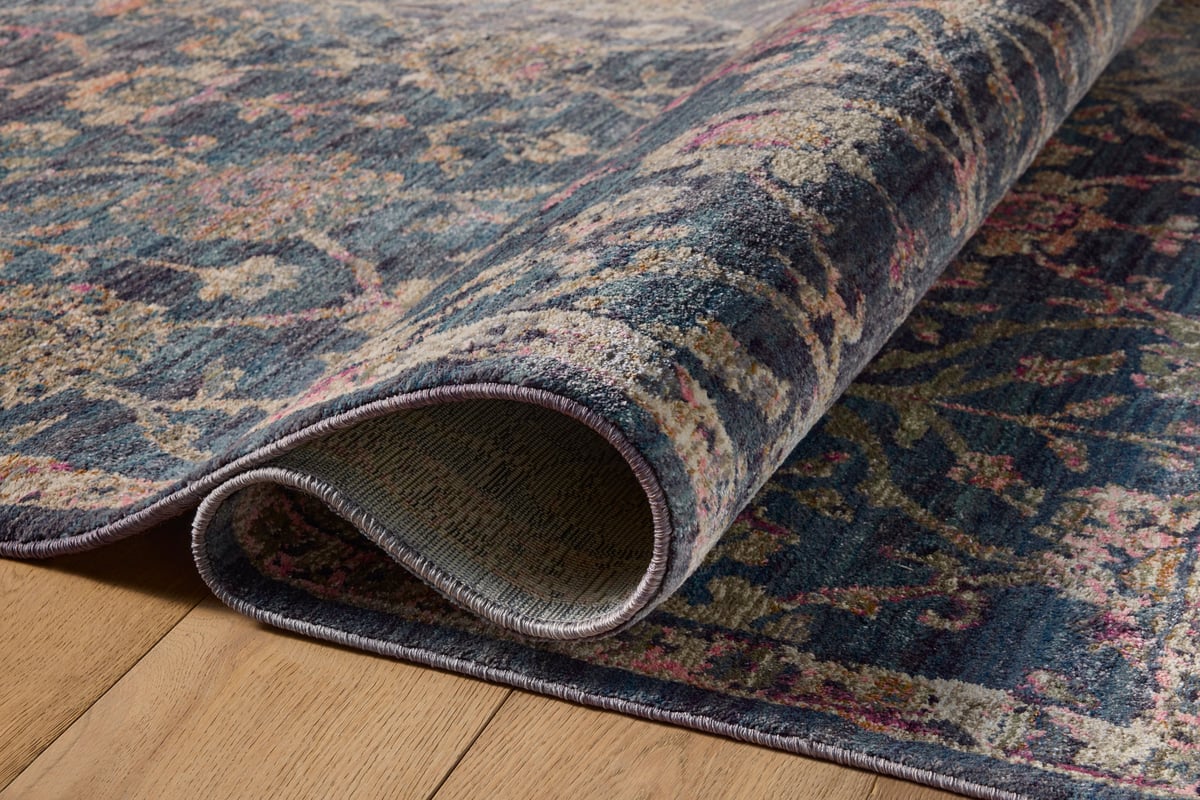Dark blue traditional rug with ornate floral damask pattern in cream and rose tones