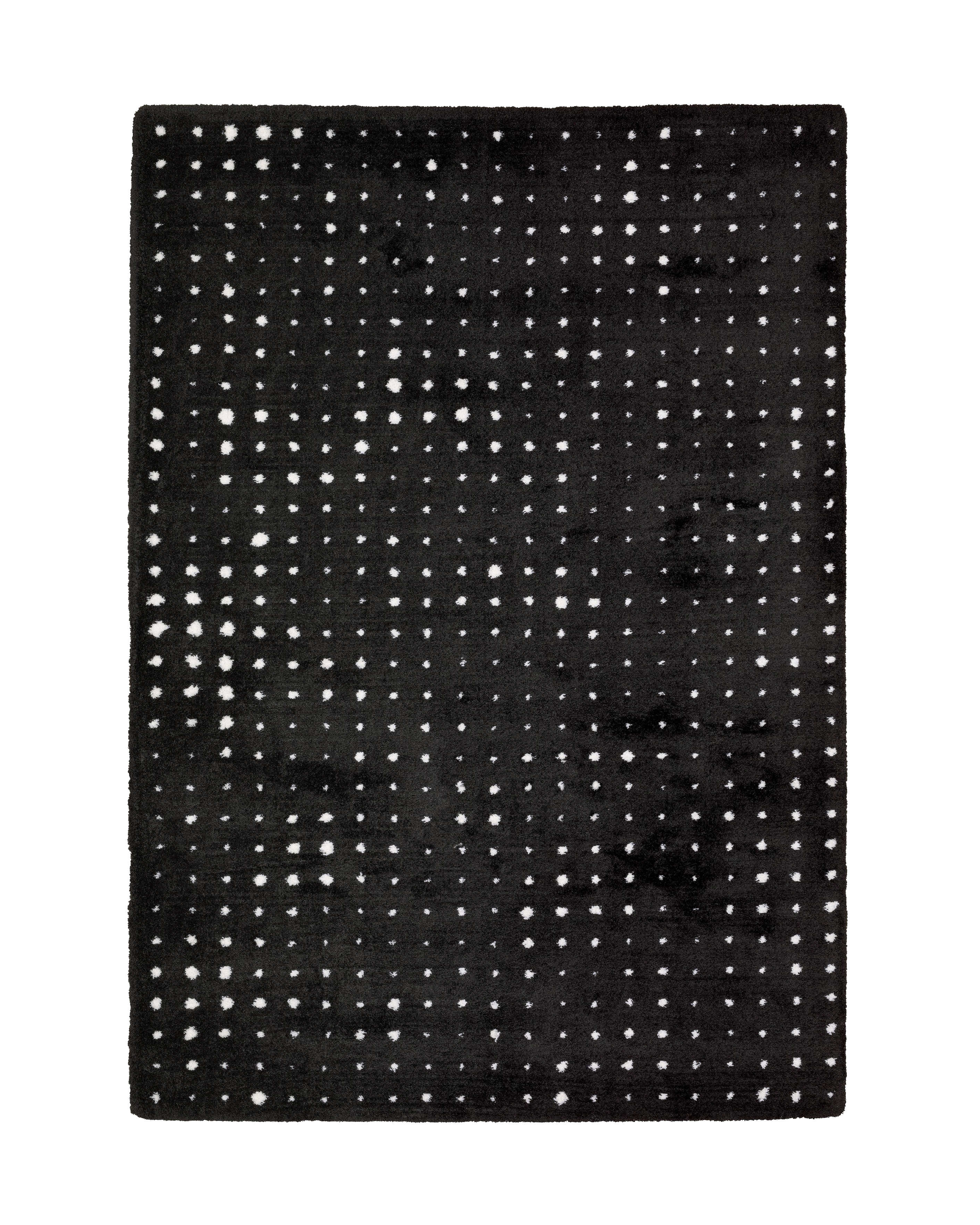 Black wool rug with white polka dot pattern and textured pile surface