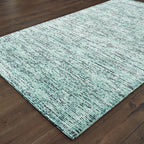 Light blue textured area rug in modern bedroom with wooden furniture