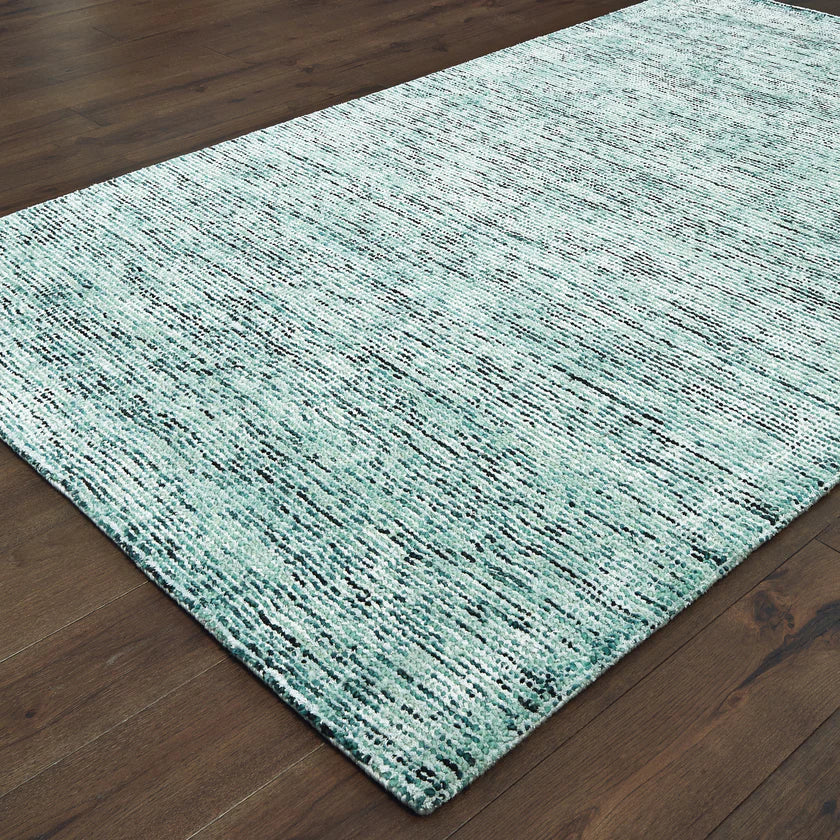 Light blue textured area rug in modern bedroom with wooden furniture