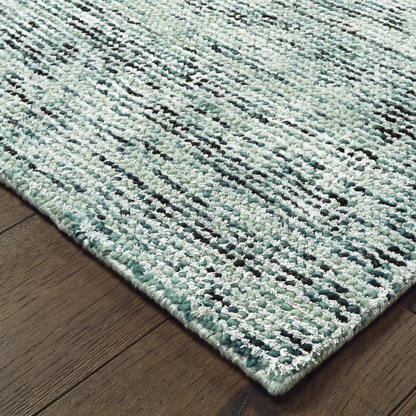 Light blue textured area rug in modern bedroom with wooden furniture