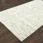 Handwoven natural fiber rug with cream and gray textured pattern throughout