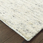 Handwoven natural fiber rug with cream and gray textured pattern throughout