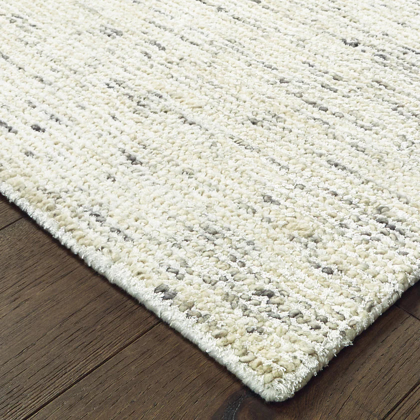 Handwoven natural fiber rug with cream and gray textured pattern throughout
